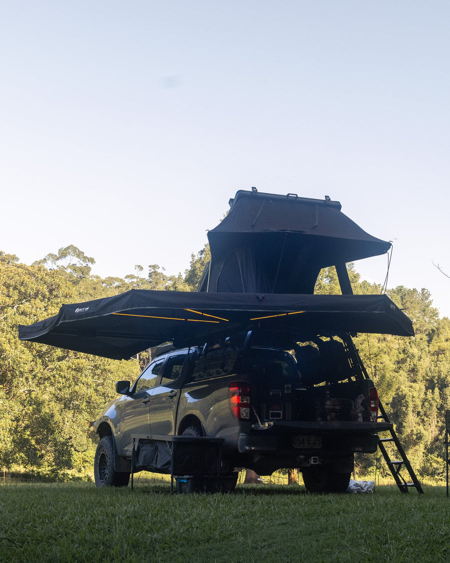 Quick-release awning and rooftop tent deployed on a BT-50 at camp
